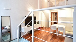 A modern apartment with a staircase, a dining area, and a kitchen. - Cozy flat in Isola facing Bosco Verticale - Intrho (Milan)