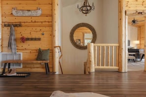 A wooden interior with a bench, a mirror, and a sign reading 'Big Bear Lake.'