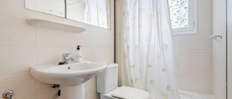 A bathroom with a sink, toilet, and bathtub.