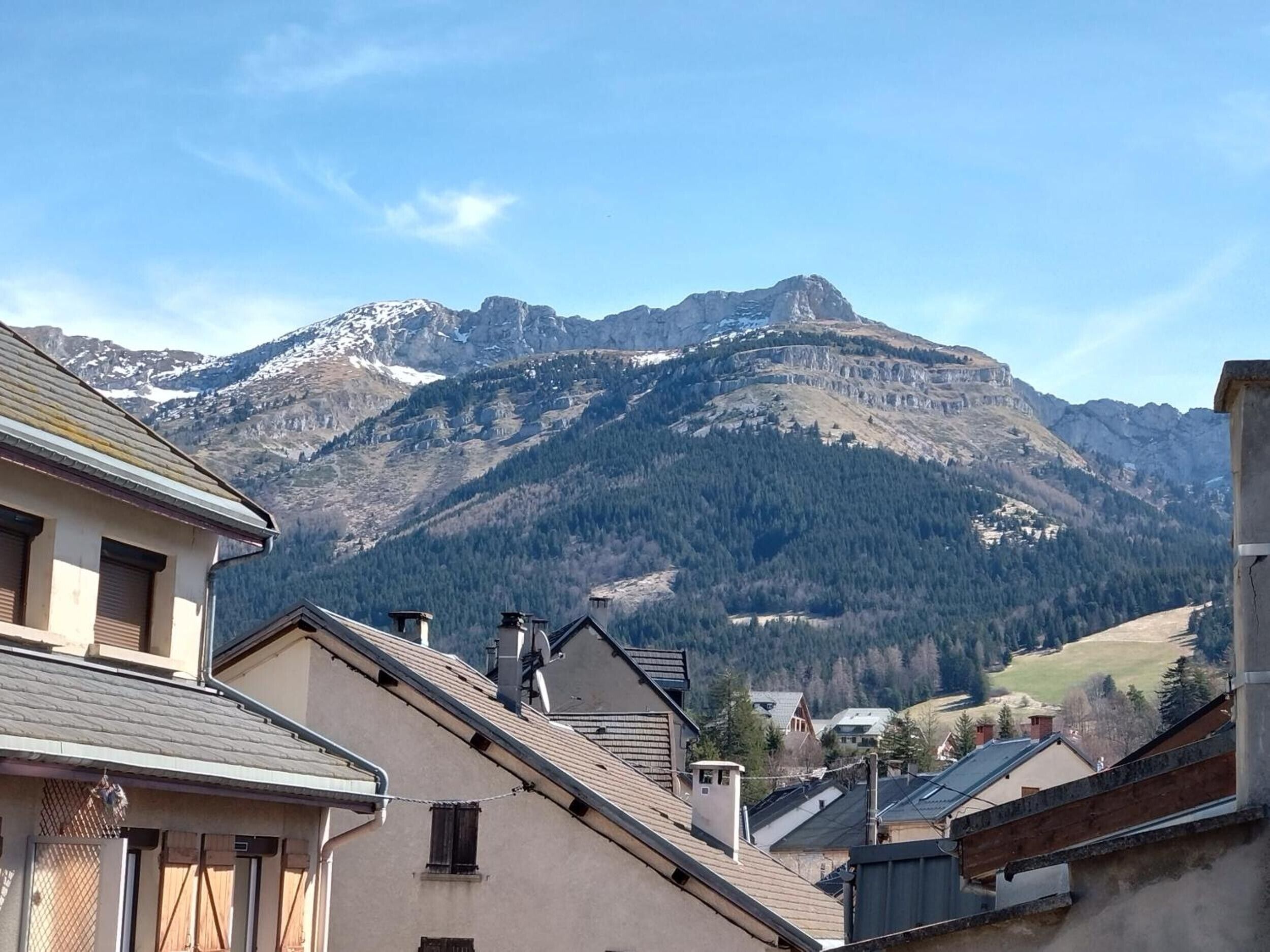 Un paisaje montañoso con edificios en primer plano.