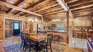 A rustic wooden interior with a dining area, kitchen, and bar. - Lake View Lodge (Waterfront in Town!) (Greenville)
