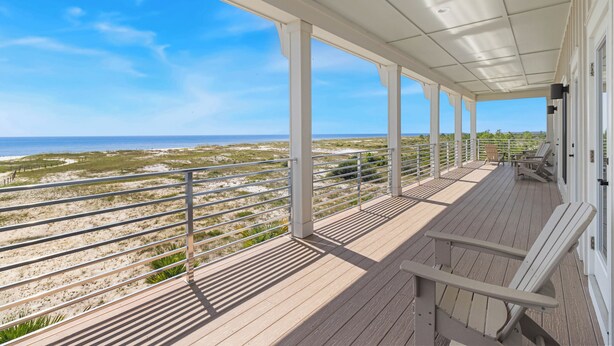 A covered outdoor deck with a view of the beach and ocean. - NEW HOME! AMISTAD IS AN UPSCALE 6BD/4BA HOME W/GULF & CANAL VIEWS, PRIVATE POOL! (Mexico Beach)