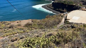 A coastal landscape with a mountain, ocean, and a paved road. - Vacation Home 'Casa Ino' with Sea View, Private Terrace and Wi-Fi (Punta del Hidalgo)