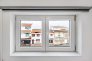 A window with a white frame and a roller blind.