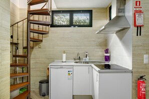 A compact kitchen with a built-in dishwasher, a window, and a fire extinguisher. - Apartment 'Host Albina' with Private Terrace, Wi-Fi and Air Conditioning (Funchal)