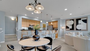 A modern kitchen with wooden cabinets, a central island, and pendant lighting. - Convenient and Accessible, Park + BBQ + Pool +Gym by Hello Hideout (San Jose)
