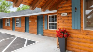 A row of log cabins with blue shutters and a sign indicating an office. - Rustic Riverside Lodge | WiFi | Pet-Friendly (Aitkin)