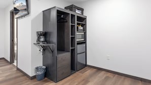 A compact room with a built-in wardrobe, a coffee machine, and a trash bin. - Rustic Riverside Lodge | WiFi | Pet-Friendly (Aitkin)