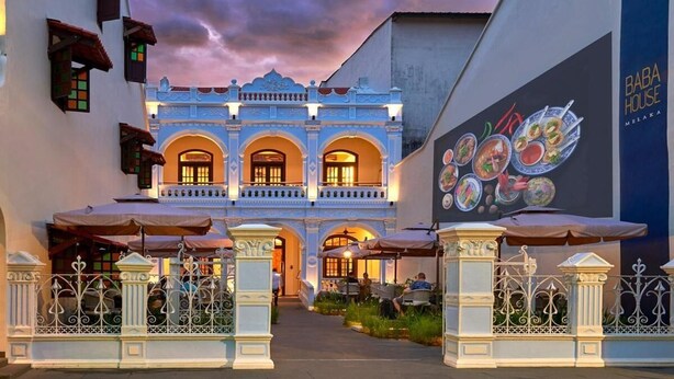 A traditional building with a balcony and a dining area.