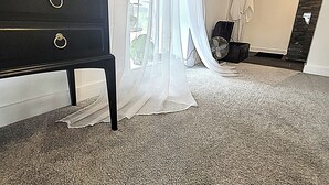 A bedroom with a large window, a black dresser, a fan, and a coat rack. - 1 Bed Barn Retreat - Fireplace, Patio, Parking (Lincoln)