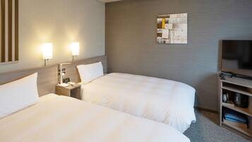 A hotel room with two beds, a TV, a nightstand, and a wall-mounted artwork.