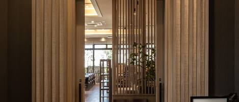 A restaurant entrance with a wooden facade and a sign reading "Restaurant NAGOMI".