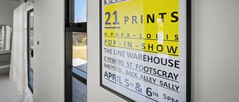 A sign advertising a pop-in show at The Line Warehouse, located at 2 Yewers St, Footscray, with events on April 5th and 6th at 5 PM.