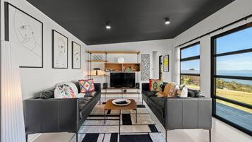 Deluxe House, Ocean View | Living area | Flat-screen TV, heated floors