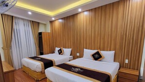 A hotel room with two beds, wooden paneling on the walls, a ceiling fan, and a wooden floor. - Queen Villa 3 Hotel DL - by Bay Luxury (Xuan Huong - Da Lat)