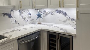A kitchen with white cabinets, a dishwasher, and a wine cooler.