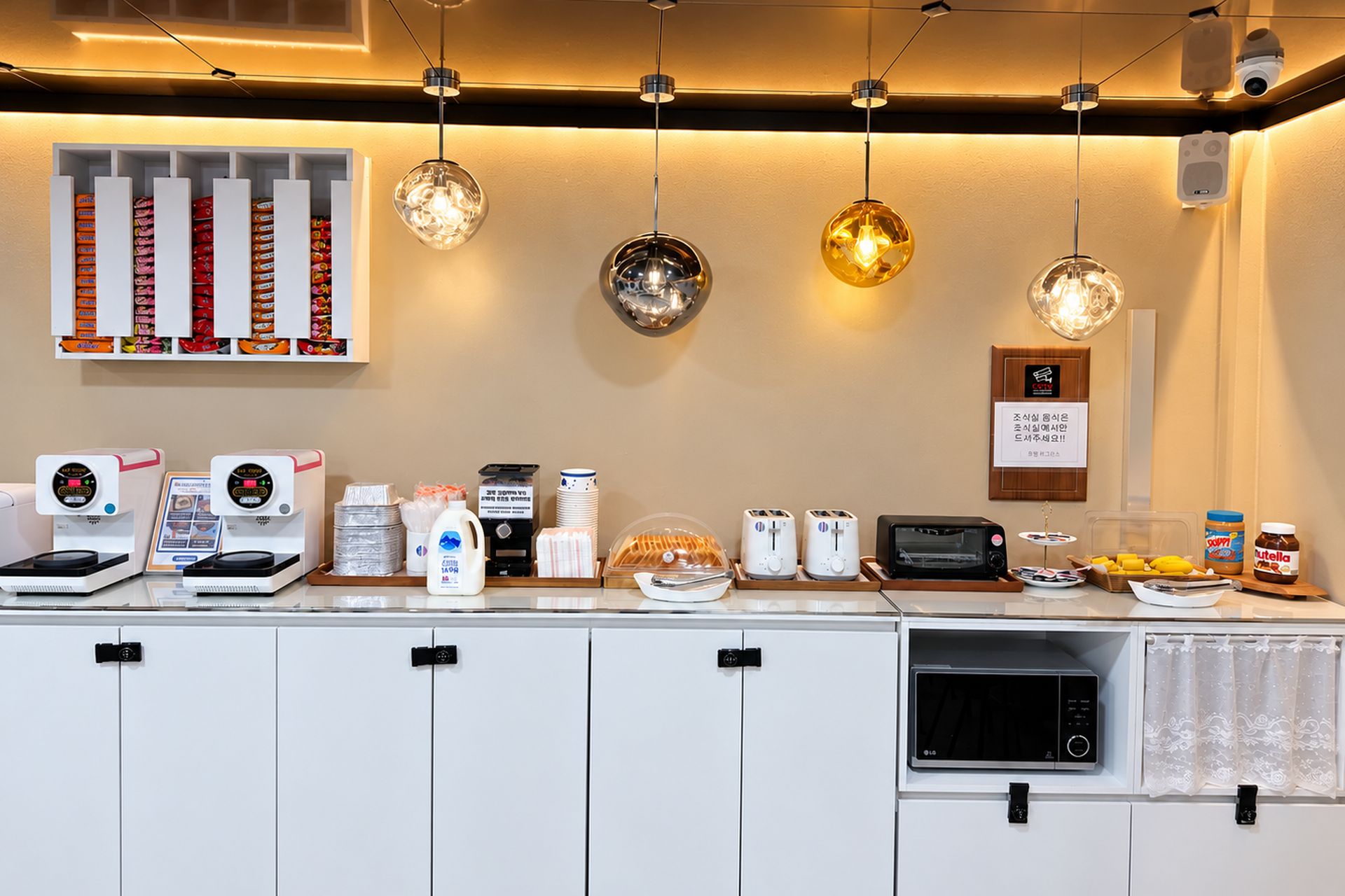 A breakfast bar with coffee machines, toasters, and condiments.