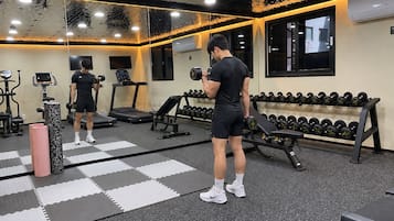 A gym with exercise equipment, a mirror, and a Star Trek-themed wall.