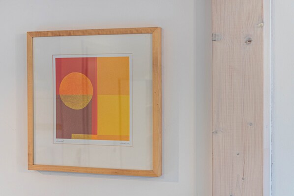 A framed artwork on a wall.