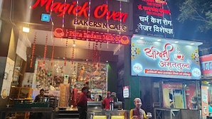 A bakery and cafe named Magick Oven with a sign in multiple languages, including English and Hindi. - Magick Oven (Ujjain)