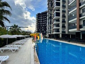 Seasonal outdoor pool, pool loungers