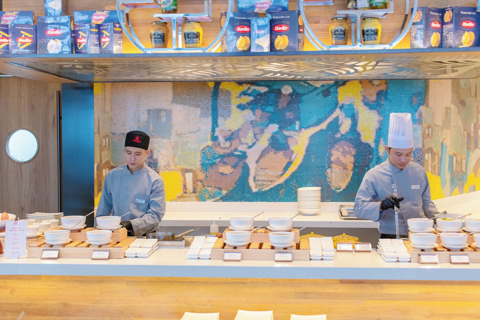A buffet setup with multiple serving stations, each equipped with bowls, plates, and utensils.