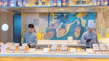 A buffet setup with multiple serving stations, each equipped with bowls, plates, and utensils.