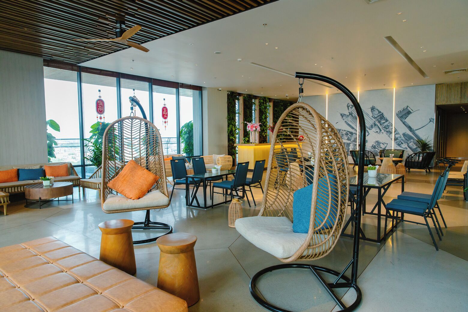 A modern lounge area with wicker chairs, sofas, and a dining area.