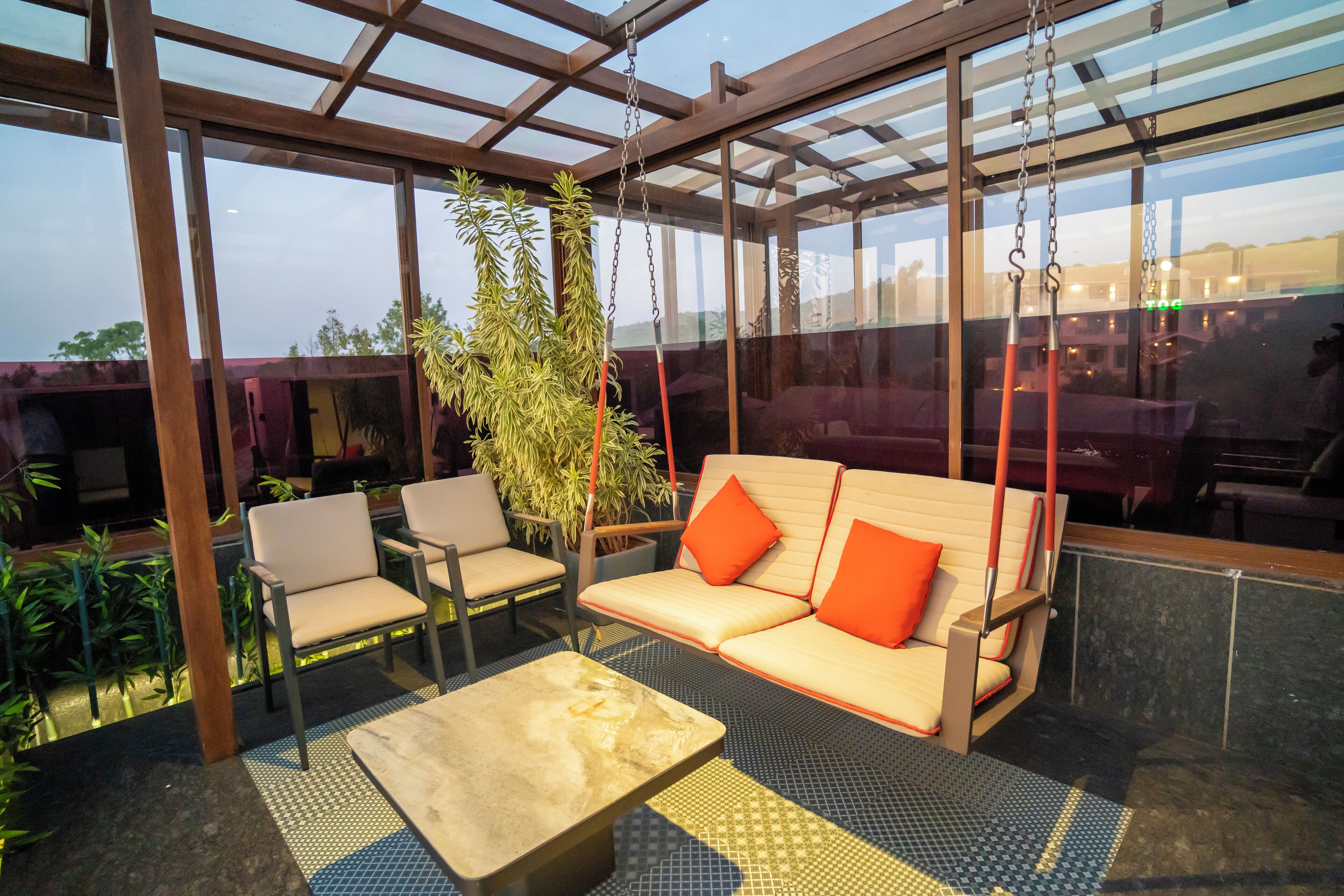 A modern outdoor seating area with a sofa, chairs, and a coffee table.