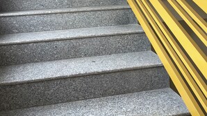 A staircase with granite steps and a yellow handrail. - Shubham Cottage (Manali)