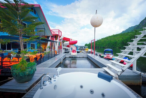 A waterfront property with a swimming pool, a slide, and a boat dock. - Paenaifun Resort (Si Sawat)