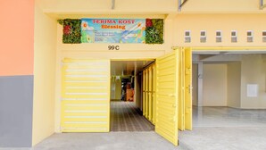 A yellow entrance with a sign reading "TERIMA KOST Blessing" and a number "99C". - Hotel O Alun-Alun Purwokerto Near Gor Satria Purwokerto Formerly Guest House Blessing (Purwokerto)