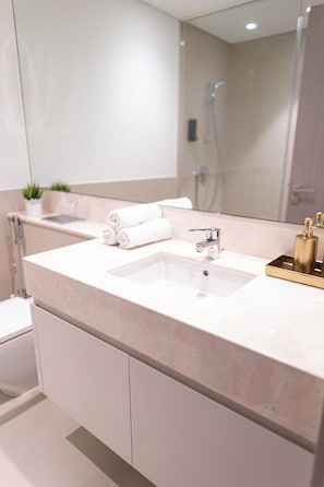 A modern bathroom with a large sink, a mirror, and a shower. - HAPPY SEASON | ACT ONE ACT TWO (Dubai)