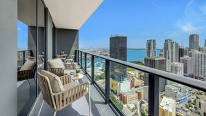 A balcony with a city view, including high-rise buildings and a body of water. - Luxury 2 Bedrooms, Balcony, Pool & Gym (Miami)