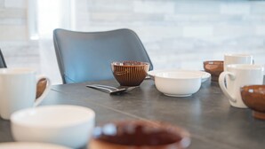 A dining table with various bowls, cups, and a chair. - Porte Bonheur (Miyakojima)