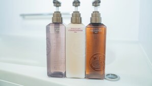 Three bottles of body care products on a white surface. - Porte Bonheur (Miyakojima)