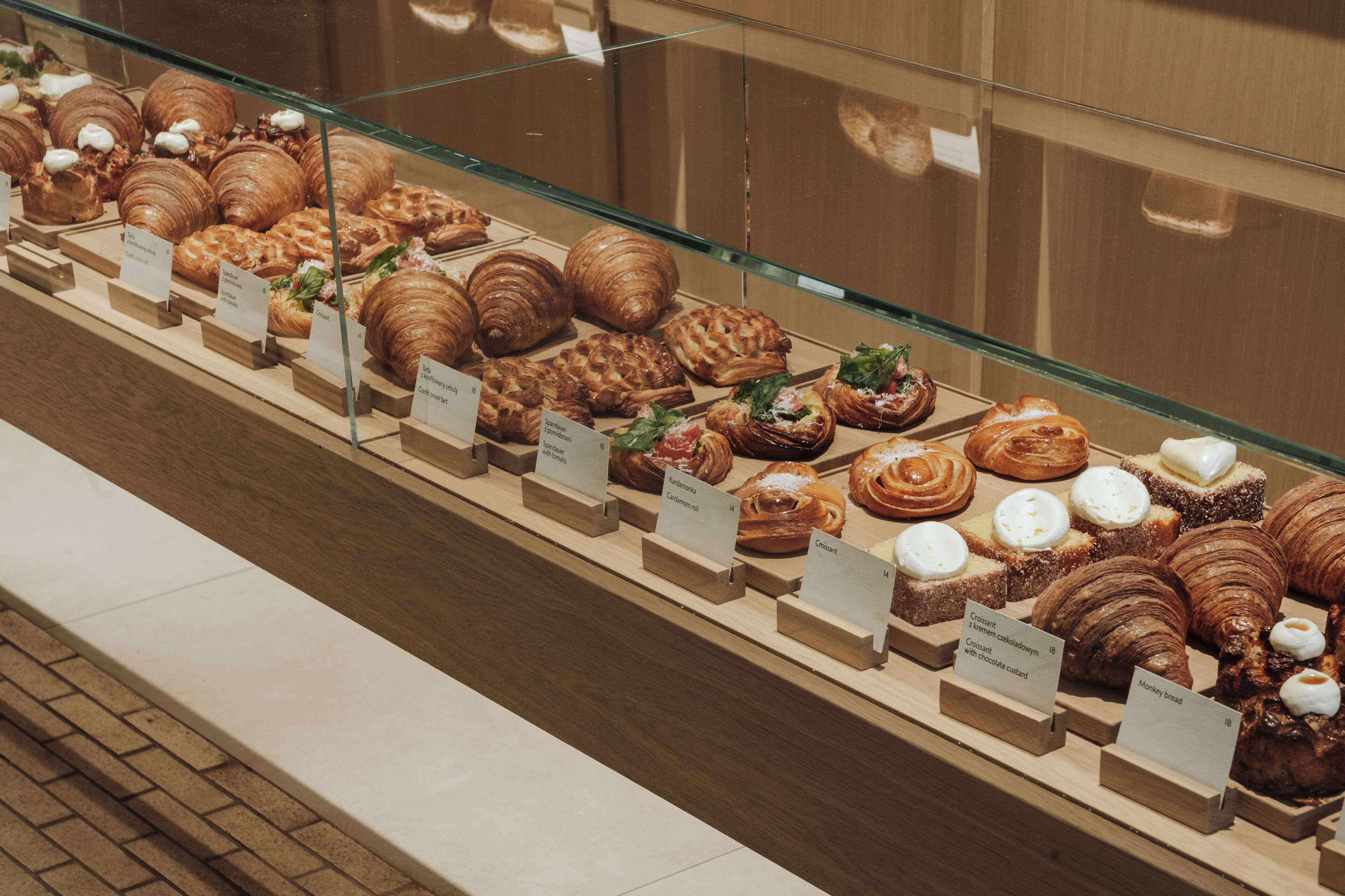 A bakery display case with various pastries and desserts.