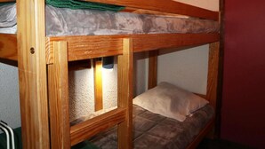 A bunk bed with a mattress and pillows.