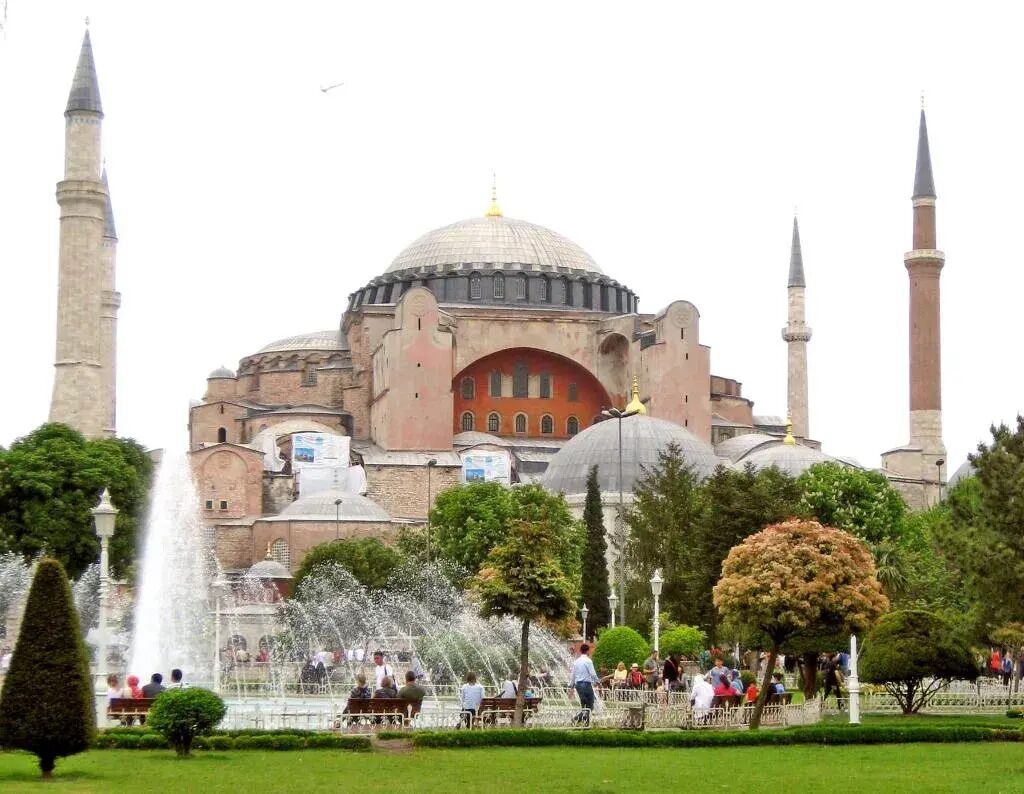 A historic building with a large central dome and four minarets.