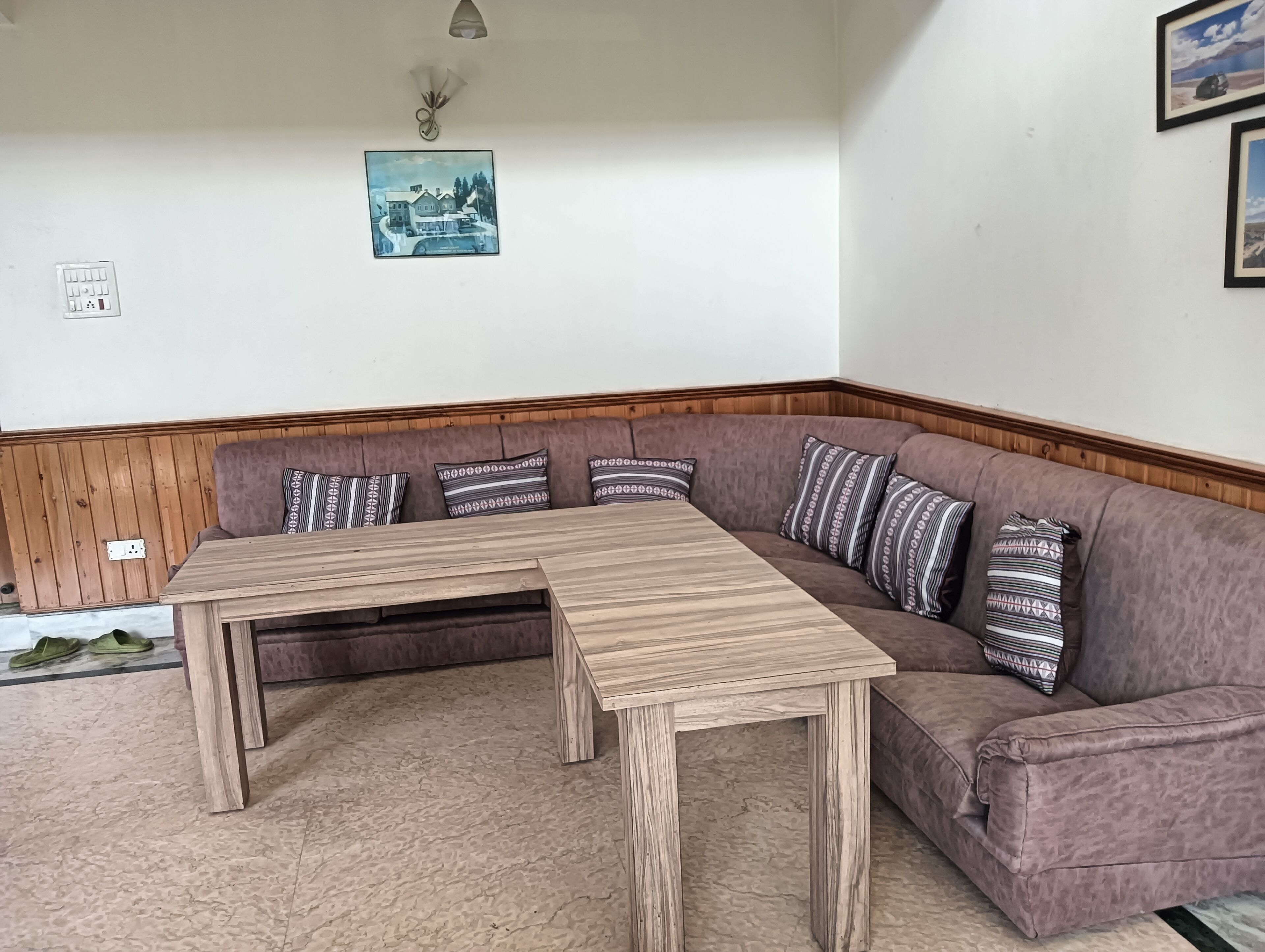 A corner seating area with a wooden table and a cushioned bench.