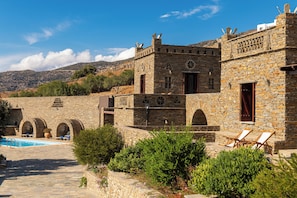 A stone building with arches and a pool area. - Andros Serenity Retreat - Adults Only (Andros)