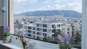 A window with a view of a cityscape and mountains.