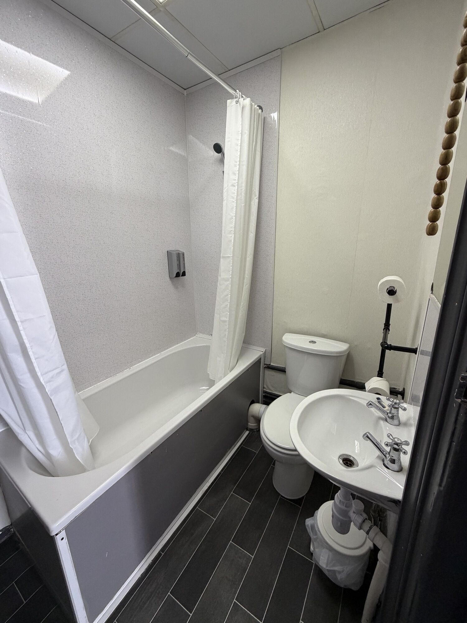 A bathroom with a bathtub, toilet, and sink.