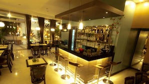 A restaurant with a bar area, multiple tables, and chairs. - Townhouse OAK Metro Manila Near Osmena Highway PNR Pasay formerly Avitel Hotel (Makati)