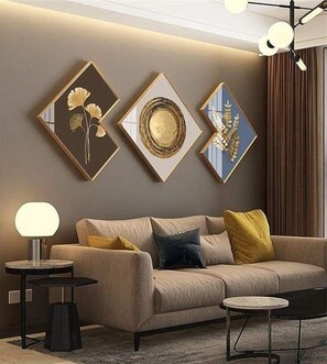 Relax in this stylish living room with a beige sofa, side table, and unique artwork.
