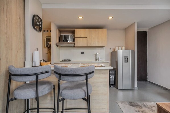 Fridge, microwave, coffee/tea maker, cookware/dishes/utensils