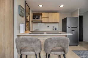 Fridge, microwave, coffee/tea maker, cookware/dishes/utensils