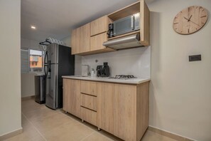 Fridge, microwave, coffee/tea maker, cookware/dishes/utensils