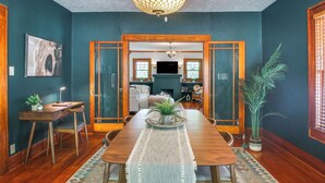 A dining area with a wooden table, chairs, a rug, and a chandelier. - Historic Craftsman Home 3 Mi to Fort Sill N Lawton (Lawton)