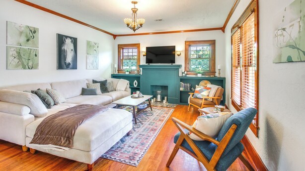 A living room with a sofa, armchairs, a coffee table, and a fireplace. - Historic Craftsman Home 3 Mi to Fort Sill N Lawton (Lawton)